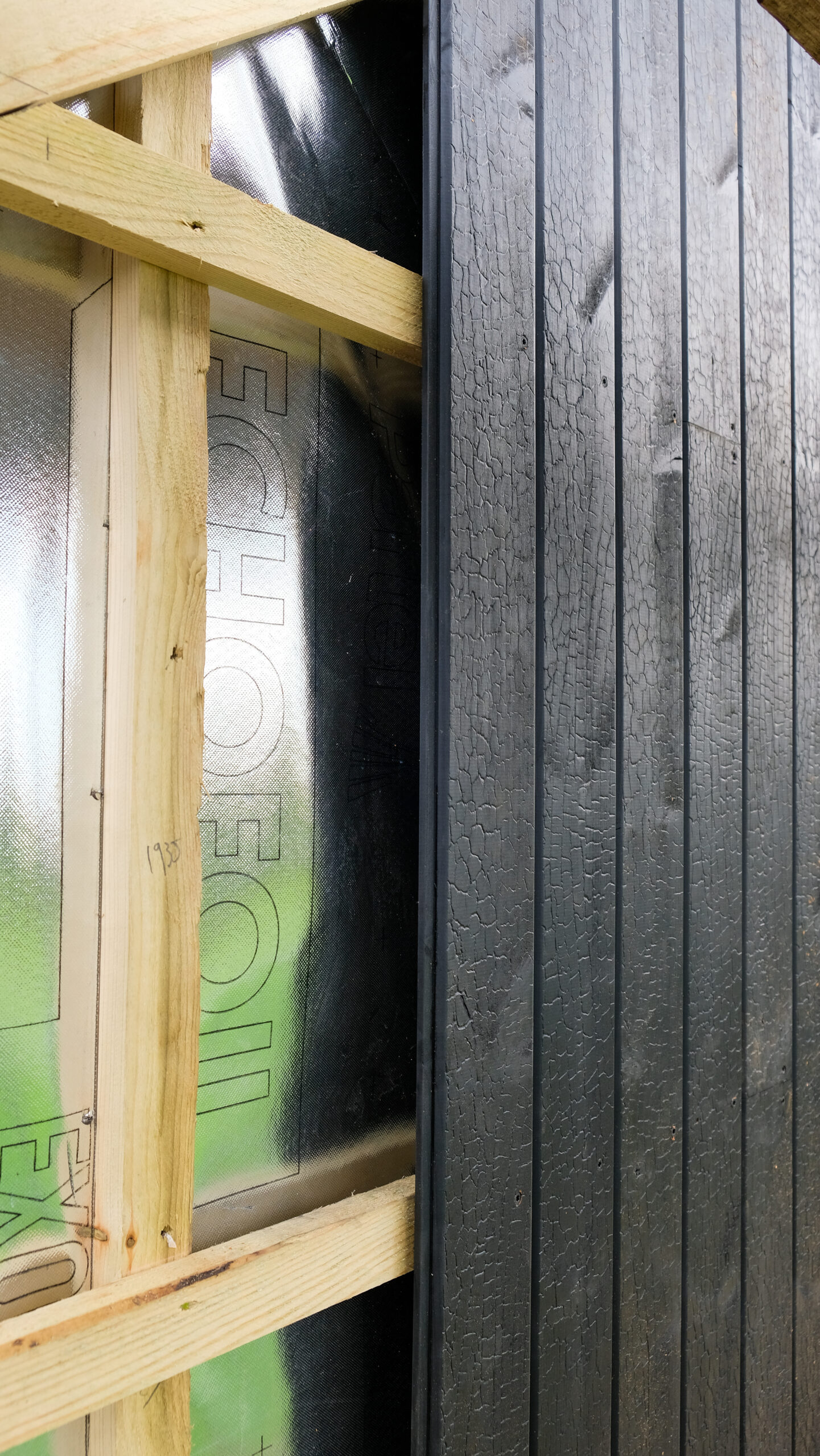 black cladding installed on timber frame with membrane behind